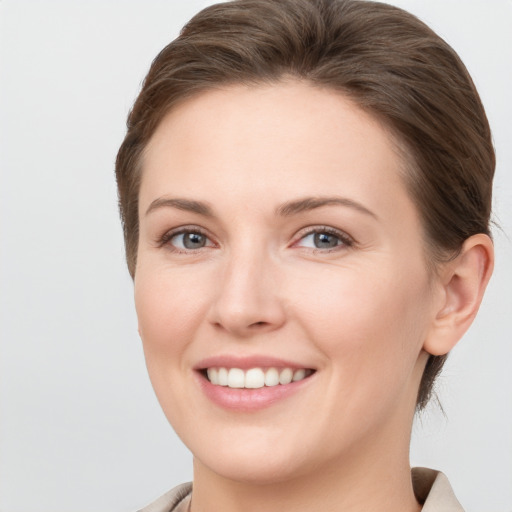 Joyful white young-adult female with short  brown hair and grey eyes