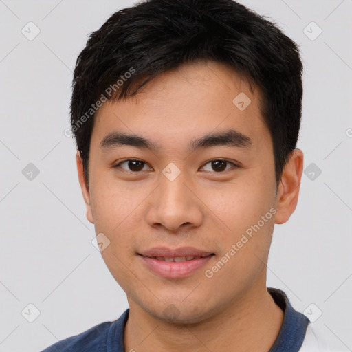 Joyful asian young-adult male with short  black hair and brown eyes