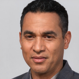 Joyful white adult male with short  black hair and brown eyes