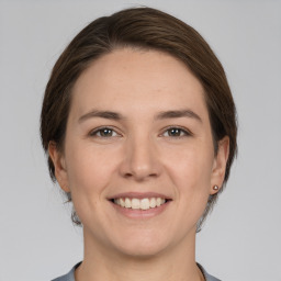 Joyful white young-adult female with medium  brown hair and brown eyes