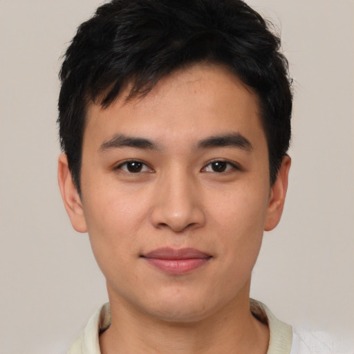 Joyful asian young-adult male with short  black hair and brown eyes