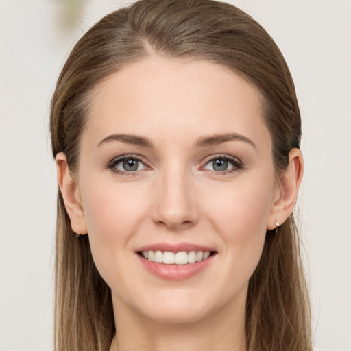 Joyful white young-adult female with long  brown hair and grey eyes