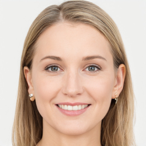 Joyful white young-adult female with long  brown hair and blue eyes