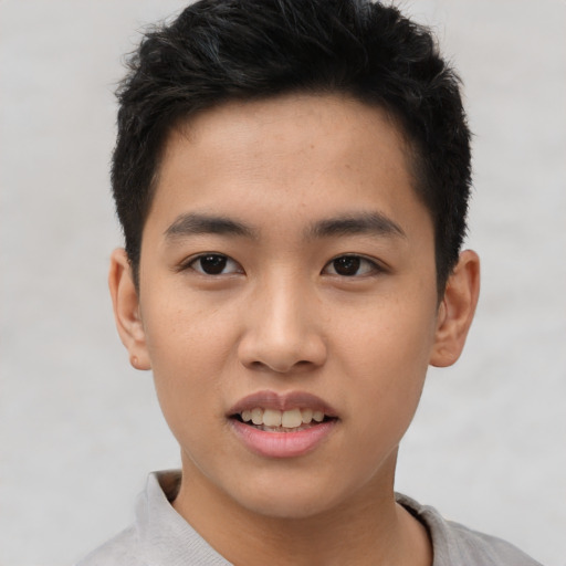 Joyful asian young-adult male with short  brown hair and brown eyes