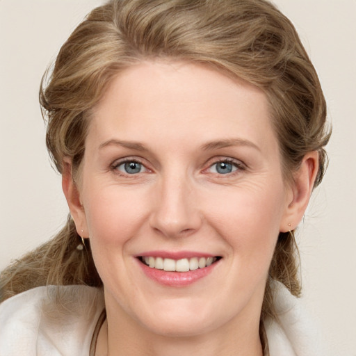 Joyful white young-adult female with long  brown hair and blue eyes