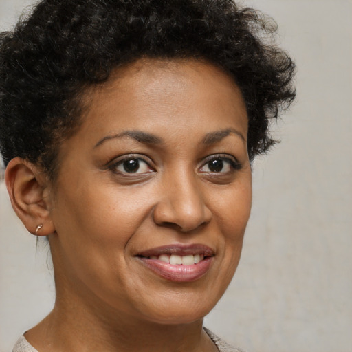 Joyful black young-adult female with short  brown hair and brown eyes