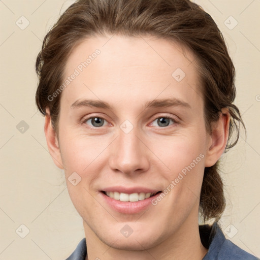 Joyful white young-adult female with medium  brown hair and grey eyes