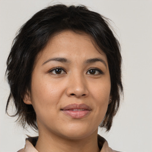 Joyful asian young-adult female with medium  brown hair and brown eyes