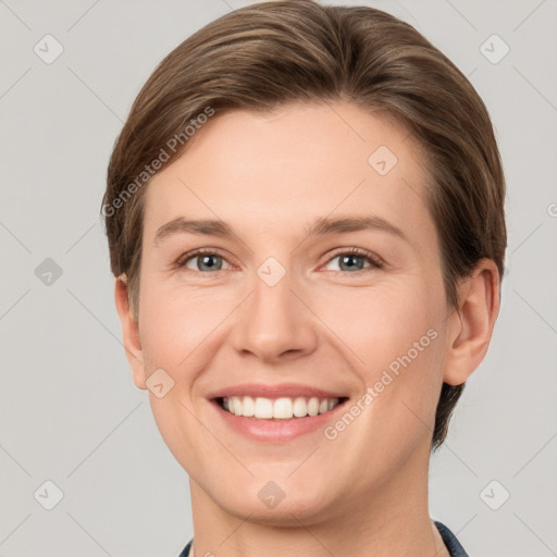 Joyful white young-adult female with short  brown hair and grey eyes