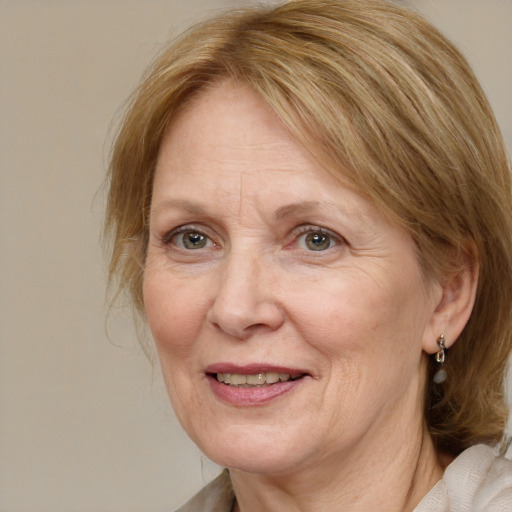 Joyful white middle-aged female with medium  brown hair and blue eyes