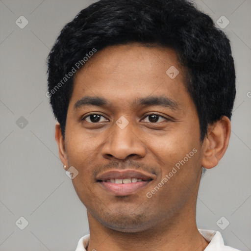 Joyful latino young-adult male with short  black hair and brown eyes