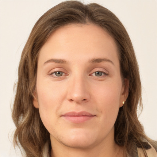 Joyful white young-adult female with long  brown hair and green eyes