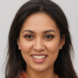 Joyful latino young-adult female with long  brown hair and brown eyes