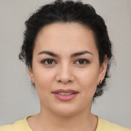 Joyful latino young-adult female with short  brown hair and brown eyes