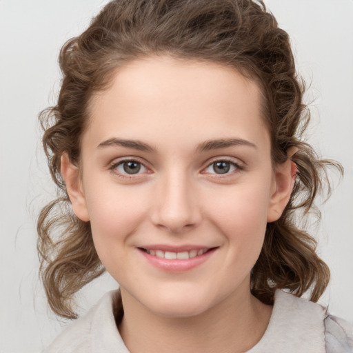 Joyful white child female with medium  brown hair and brown eyes