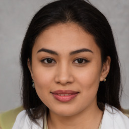 Joyful latino young-adult female with medium  brown hair and brown eyes