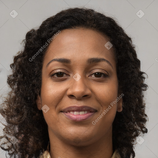 Joyful black young-adult female with long  brown hair and brown eyes