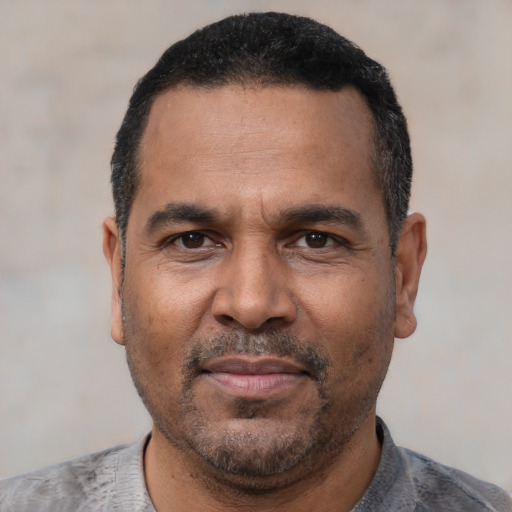 Neutral latino adult male with short  black hair and brown eyes