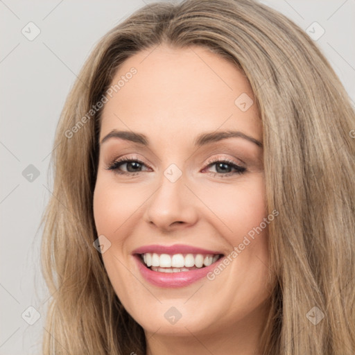 Joyful white young-adult female with long  brown hair and brown eyes