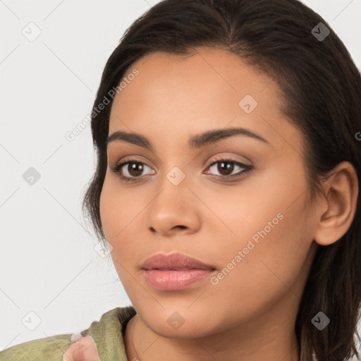 Joyful latino young-adult female with long  brown hair and brown eyes