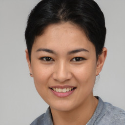 Joyful asian young-adult female with short  brown hair and brown eyes