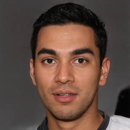 Joyful white young-adult male with short  black hair and brown eyes