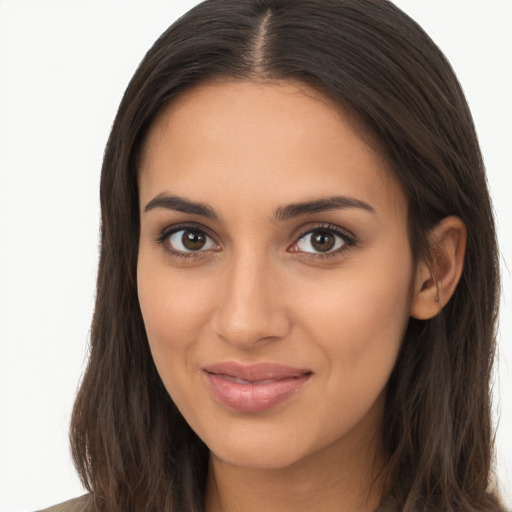 Joyful latino young-adult female with long  brown hair and brown eyes