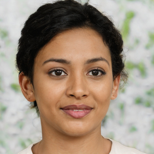 Joyful latino young-adult female with short  brown hair and brown eyes