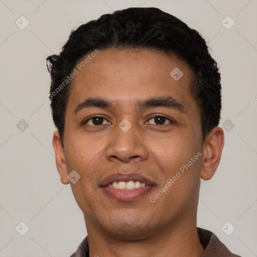 Joyful latino young-adult male with short  black hair and brown eyes