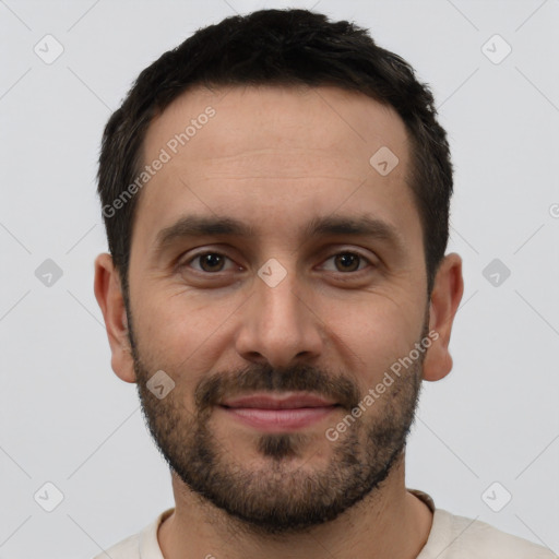 Joyful white young-adult male with short  black hair and brown eyes