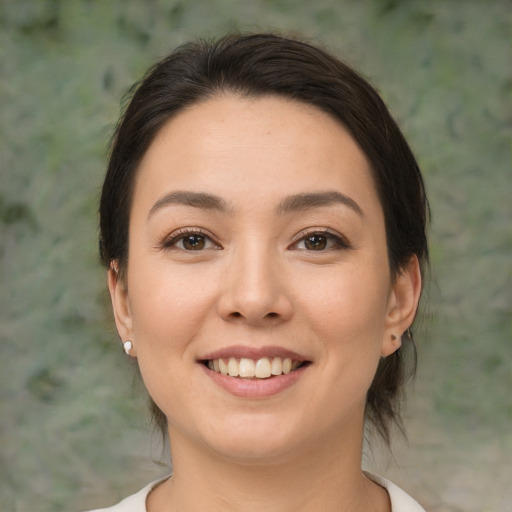 Joyful white young-adult female with medium  brown hair and brown eyes