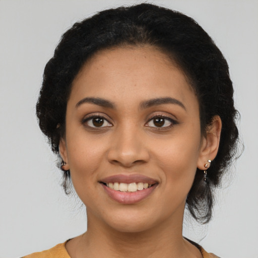 Joyful latino young-adult female with long  black hair and brown eyes