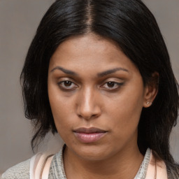 Joyful black young-adult female with medium  brown hair and brown eyes