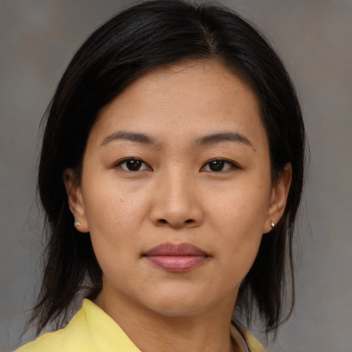Joyful asian young-adult female with medium  brown hair and brown eyes