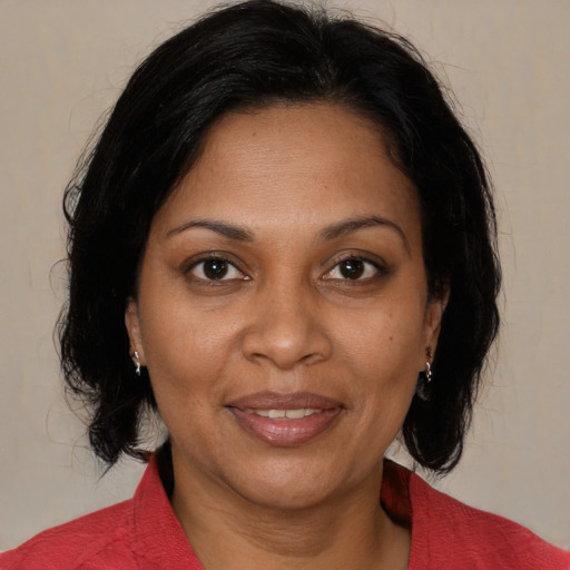 Joyful black adult female with medium  brown hair and brown eyes
