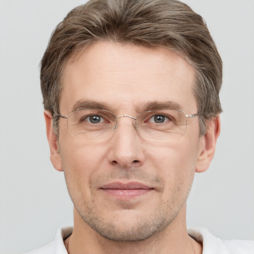 Joyful white adult male with short  brown hair and grey eyes