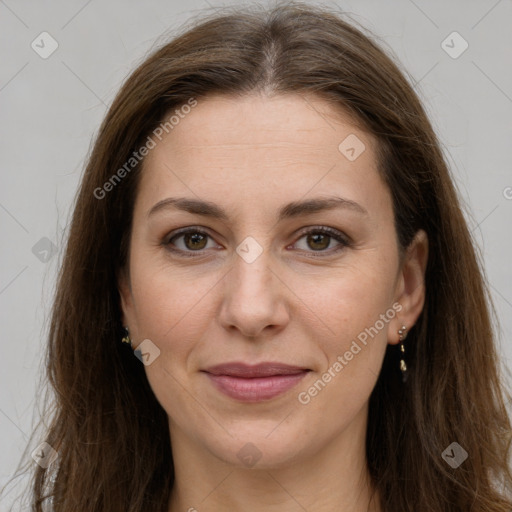 Joyful white adult female with long  brown hair and grey eyes