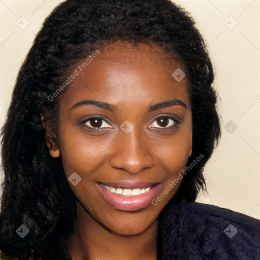 Joyful black young-adult female with long  brown hair and brown eyes