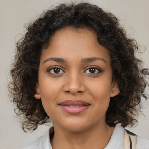 Joyful black young-adult female with medium  brown hair and brown eyes
