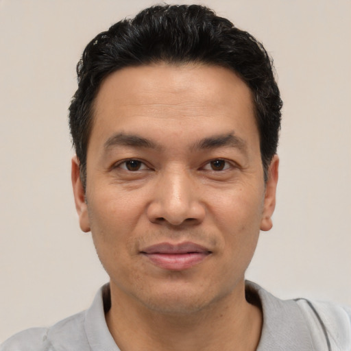 Joyful white young-adult male with short  black hair and brown eyes