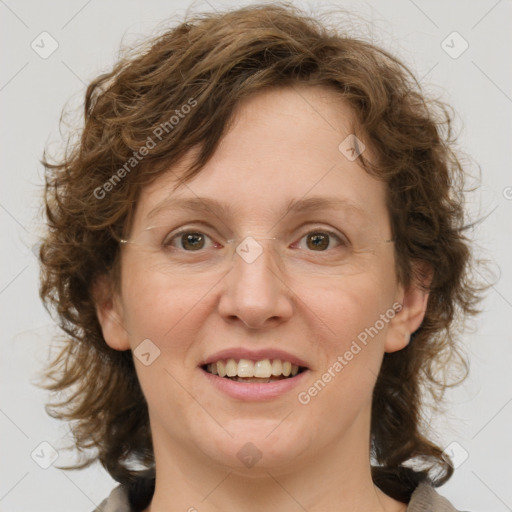 Joyful white adult female with medium  brown hair and green eyes