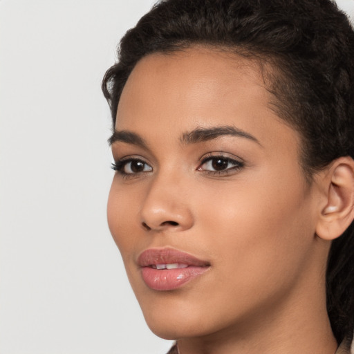 Joyful latino young-adult female with long  brown hair and brown eyes