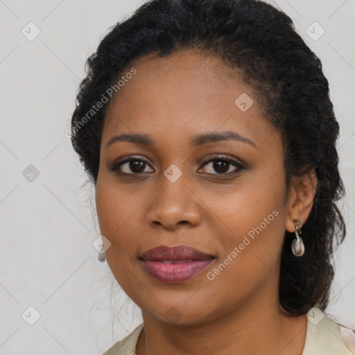 Joyful black young-adult female with long  brown hair and brown eyes