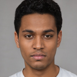 Neutral latino young-adult male with short  black hair and brown eyes