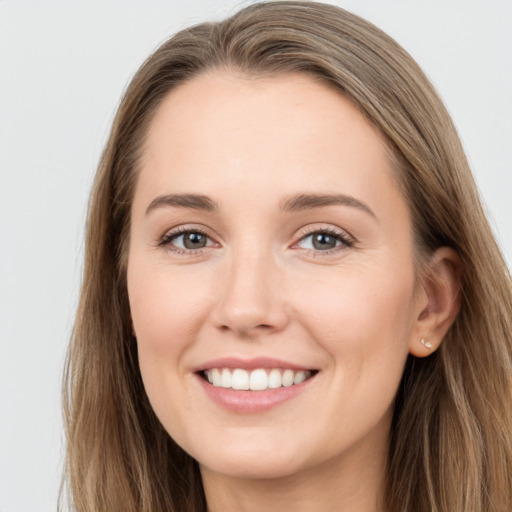 Joyful white young-adult female with long  brown hair and grey eyes