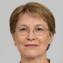 Joyful white middle-aged female with short  brown hair and grey eyes