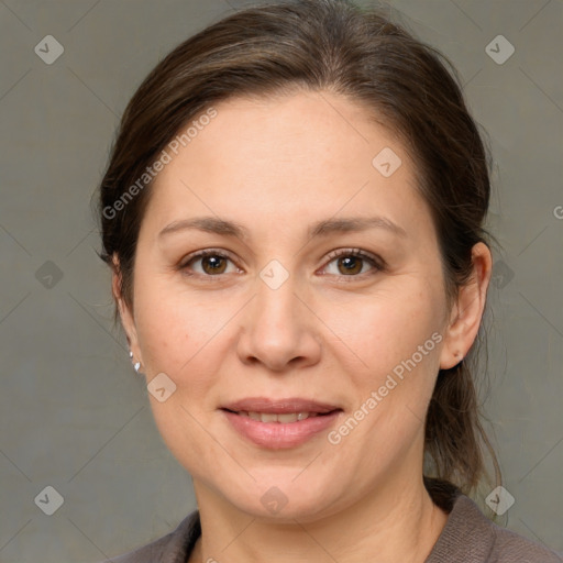 Joyful white adult female with medium  brown hair and brown eyes