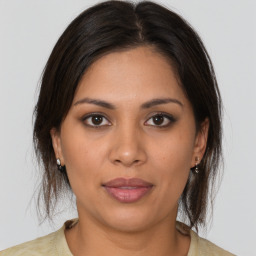 Joyful latino young-adult female with medium  brown hair and brown eyes