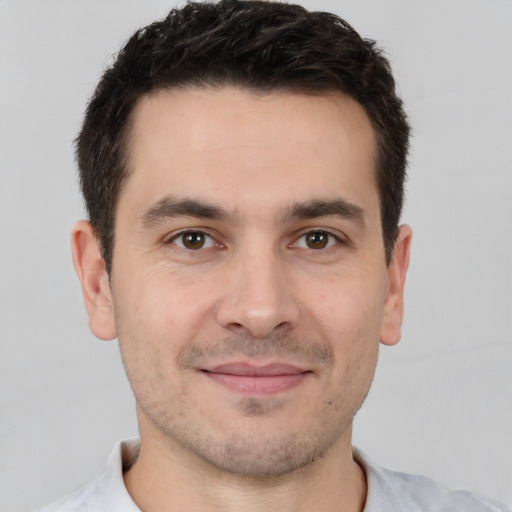 Joyful white young-adult male with short  brown hair and brown eyes