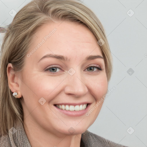 Joyful white young-adult female with long  brown hair and blue eyes